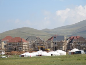 A bit farther out of town the new rich build their mansions with the help of workers who stay in traditional gers.