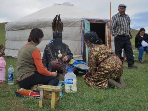 A woman talks to one of her ancestral spirits which has taken over the body of the shaman.