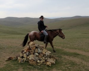 Circling a "odoo" on my quarter horse. These sacred rock piles are meant to be circumambulated three times in a clockwise motion. It's a practice to pay respect to the spirits of the mountains and valleys and is generally observed by rural Mongolians.