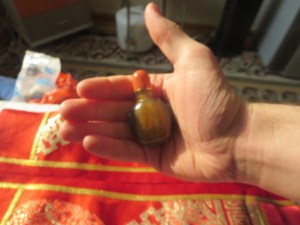 The proper way to hand off a snuff bottle, with the silk pouch in the background.