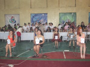 Contestants' work is on display! Each model holds a card with a number corresponding to their beautician.