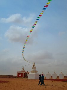 Two women cross the yard, walking with the strong wind at their back!