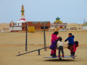 Children play despite the brisk weather and dust!