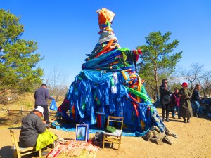 An elaborate shrine covered inn prayer flags near the Mother Tree. Mongolians walk three times around these "ovoos" and throw rice, milk, vodka, and even rocks on the shrine depending on the tradition.