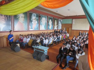 Peter and Iderugaan, a State Department alumni, give a lecture in a crowded auditorium.